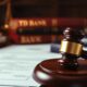 Courtroom with gavel and legal books on desk.